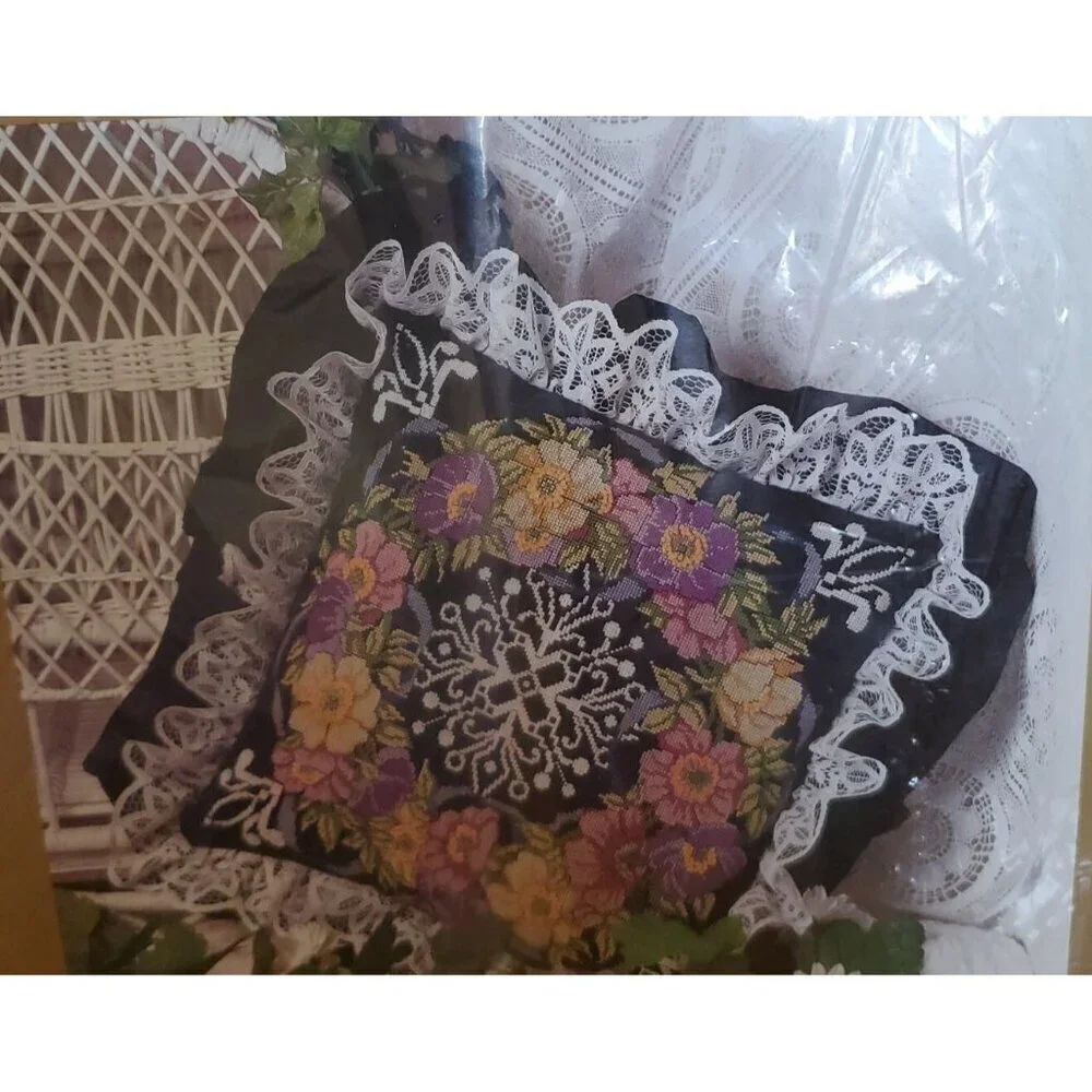 Something Special Counted Cross Stitch Kit #50687 wreath on black pillow.